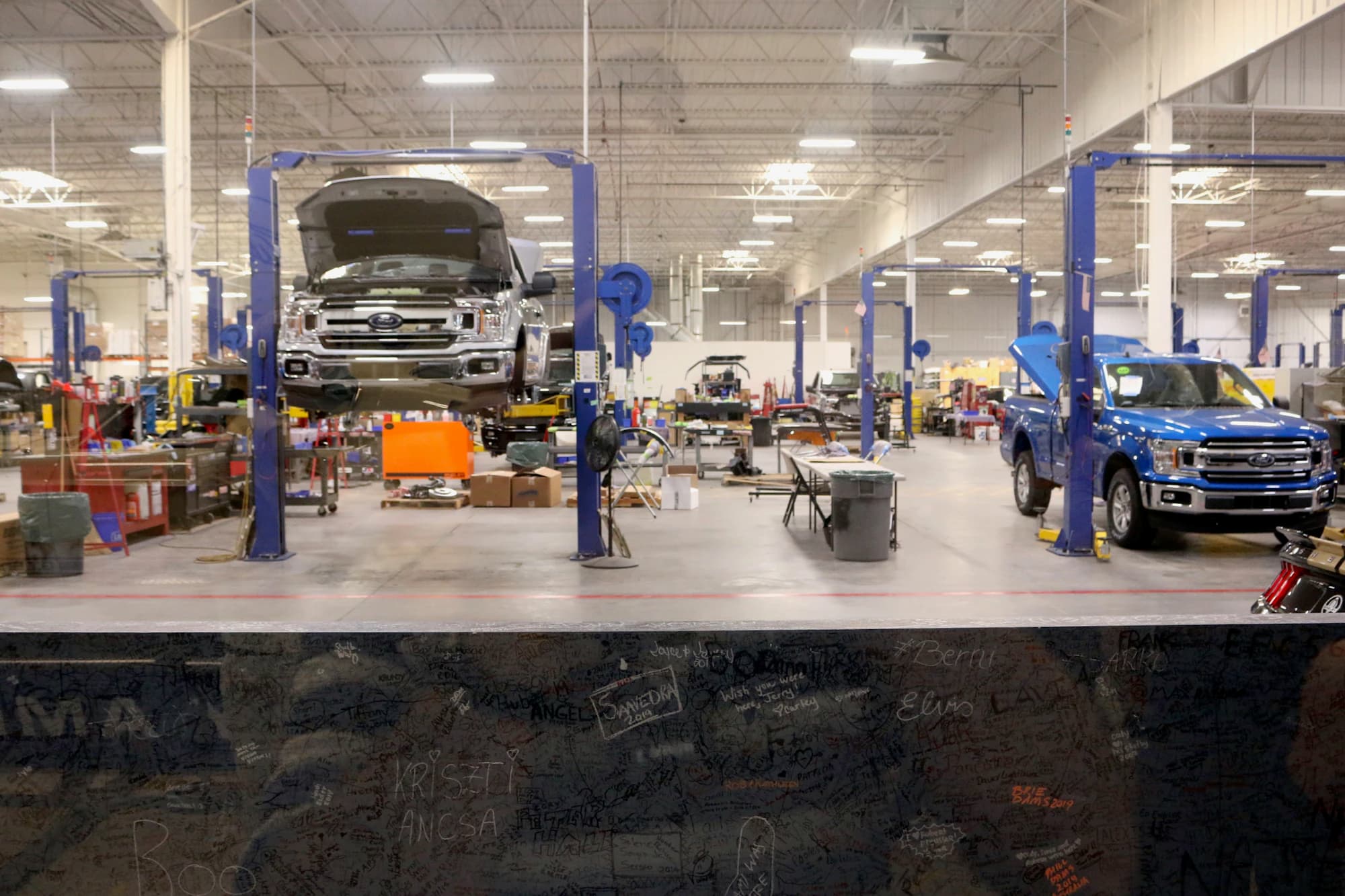 Inside the shop: cars on lifts across six bays